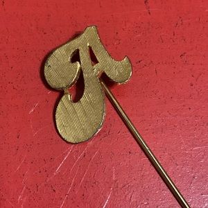 Gold toned. Letter “A” stick pin